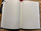 Open notebook with lined pages on a wooden surface