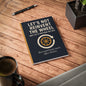 A5 notebook with the text “Let’s Not Reinvent the Wheel (But Let’s Pretend We Did)” above a wheel icon in a circular arrow, with the tagline “Buzzword bingo meets office theatre” — perfect for corporate humor and workplace stationery.